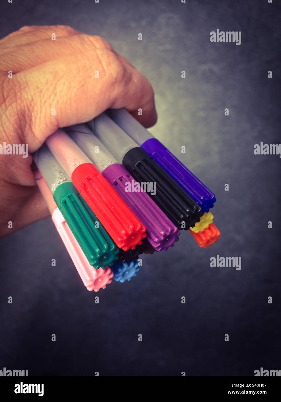 A hand full of colorful felt tip pens or markers - Smartphone Captured Stock Image
