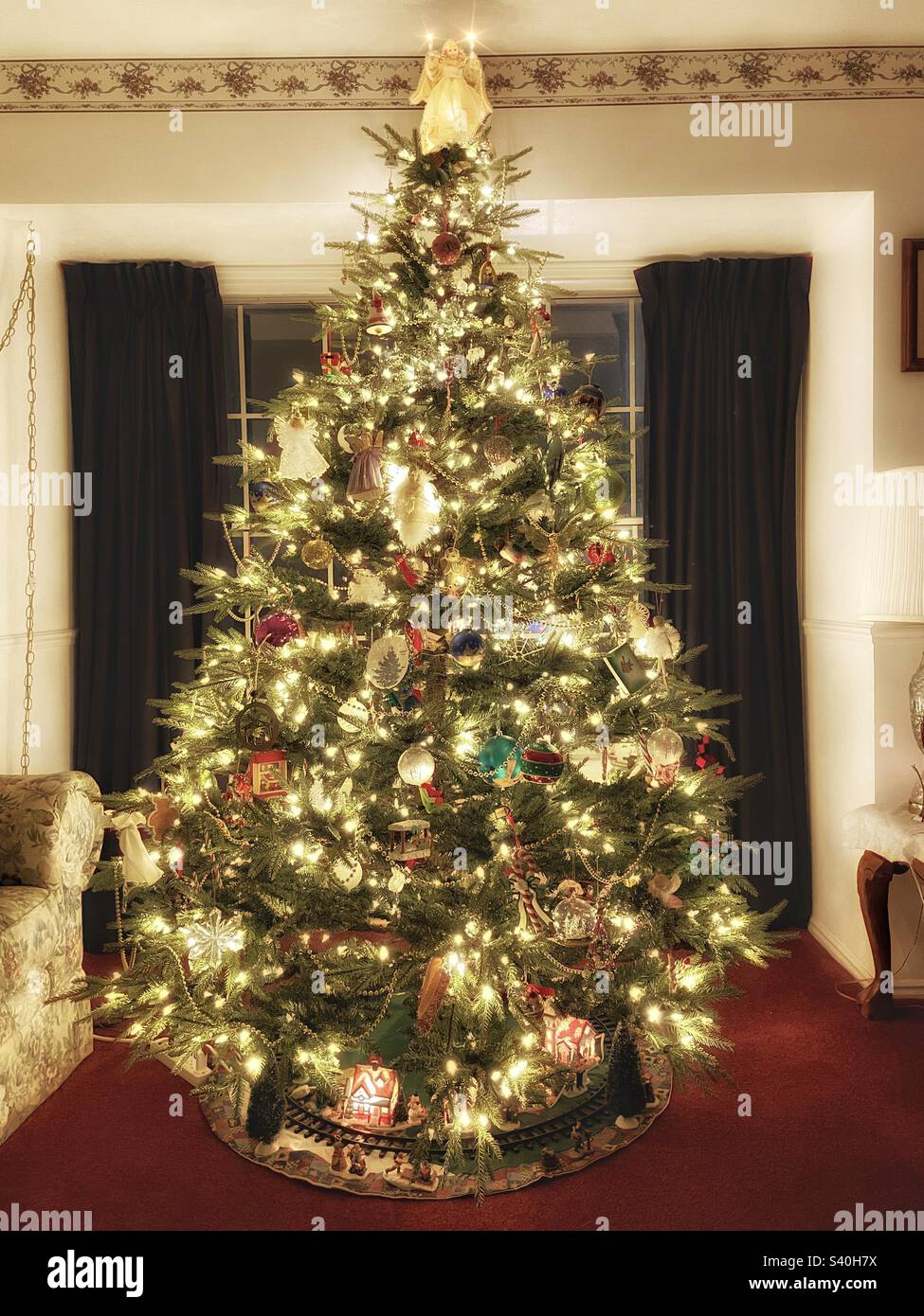 A beautiful artificial fir Christmas tree alighted with white lights