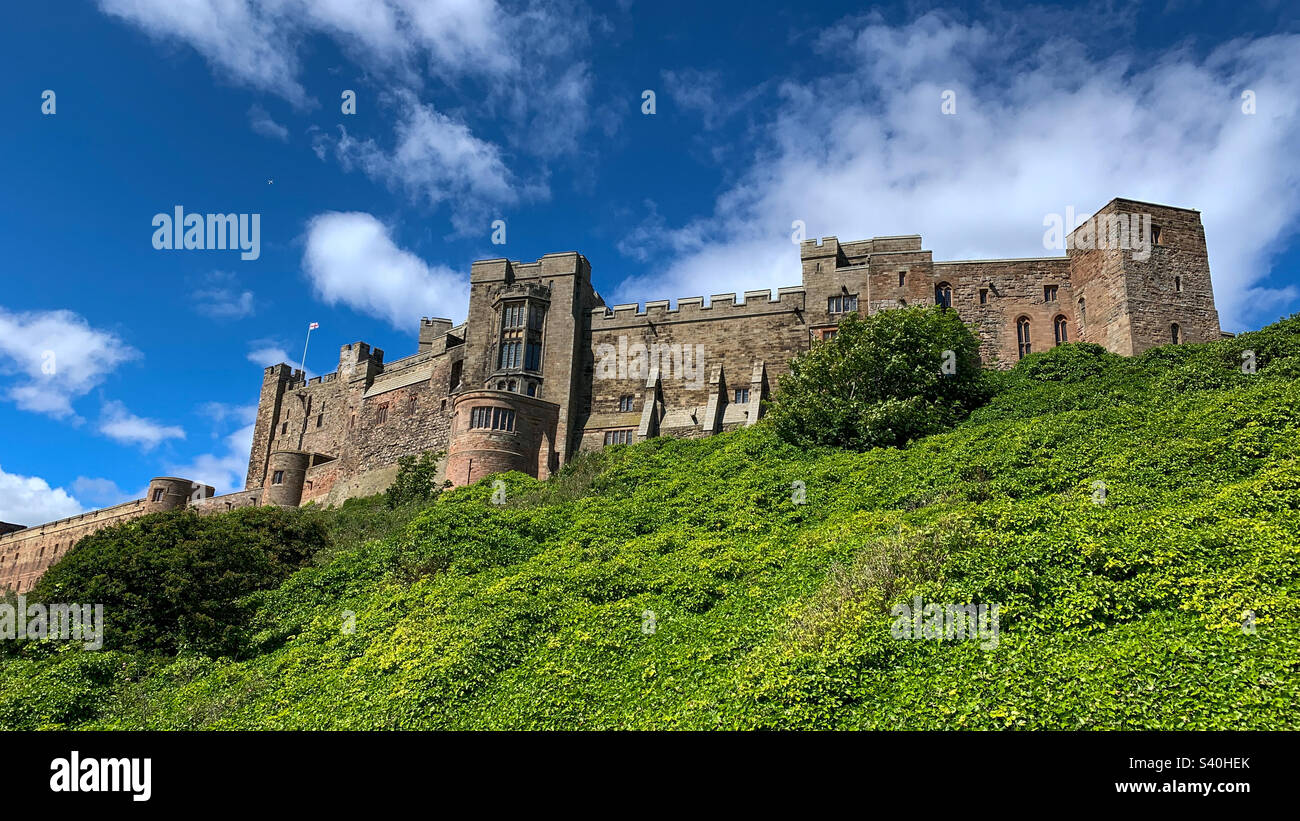 Looking up to imposing Bamburgh Castle on a sunny summers day, Northumberland, UK - Smartphone Captured Stock Image