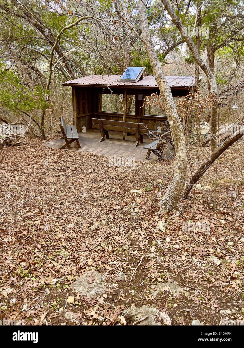 Bird blind for bird watching located at Mother Neff state park Texas. With fall leaves scattered around Stock Photo