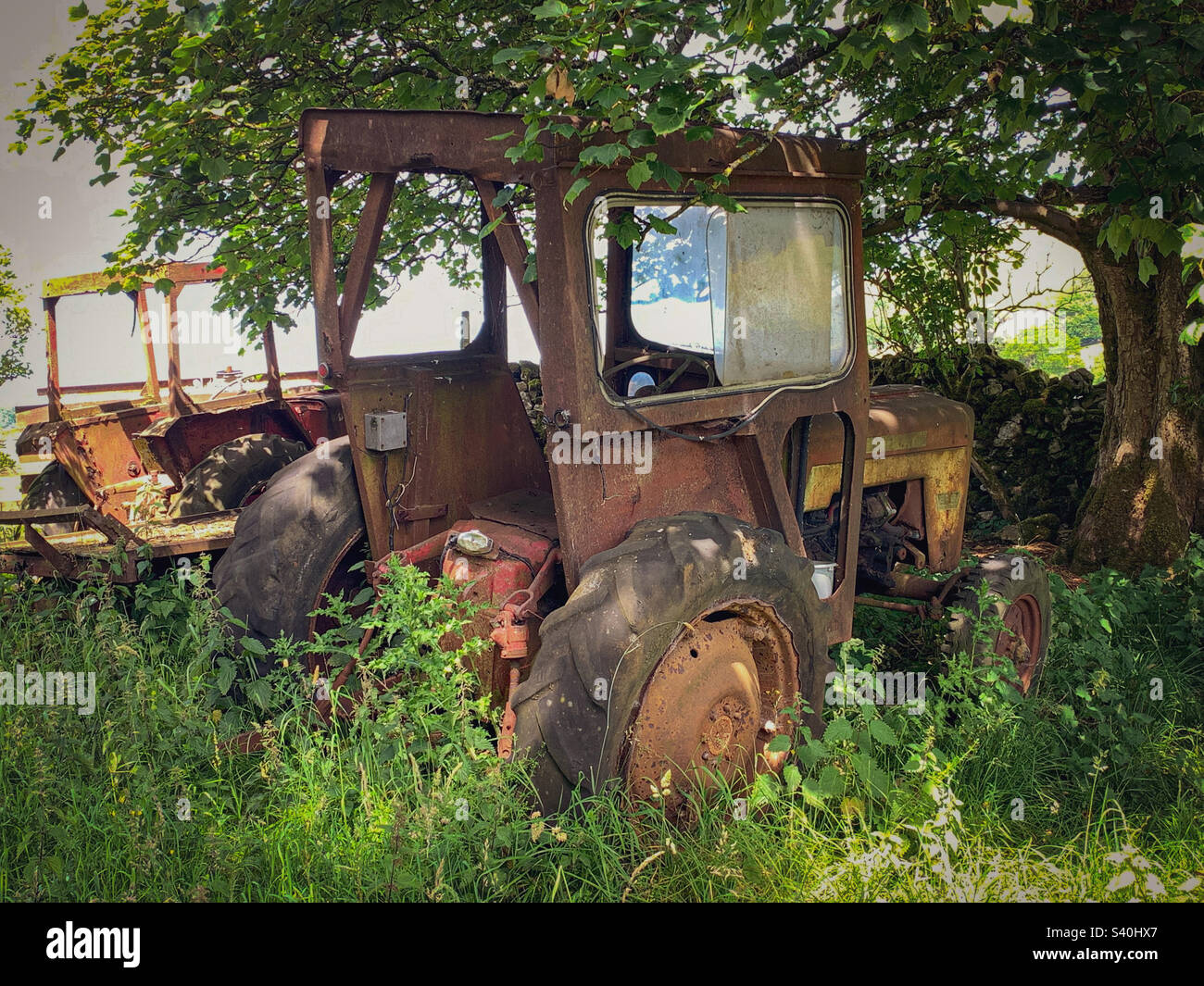 Old tractors rusting away near Kettlewell village in the Yorkshire Dales, Yorkshire, UK. A mobile phone photo with some phone or tablet post processing. - Smartphone Captured Stock Image
