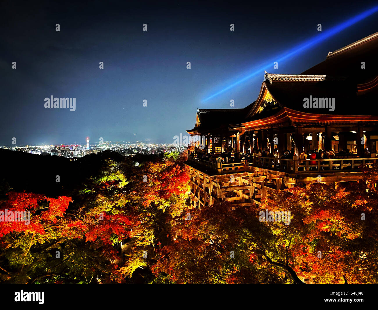 Kiyomizu-dera Temple illuminated during a special fall event. You can see Kyoto Tower in the background. Stock Photo