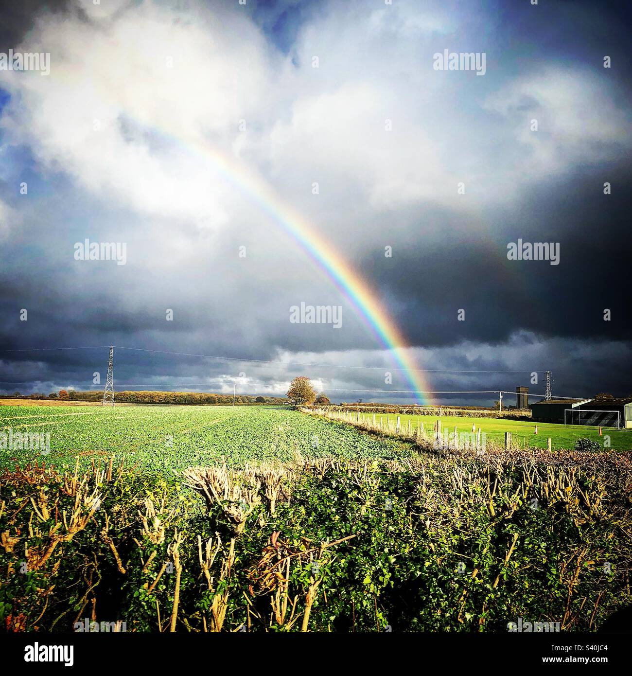Country Rainbow grey clouds Stock Photo