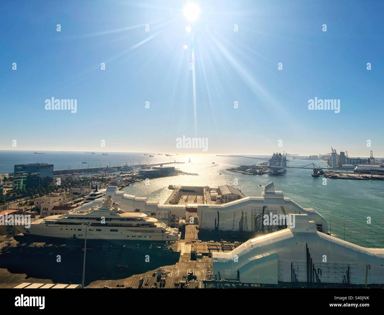 Aerial view  Barcelona’s port with yacht in dry dock sunshine reflecting on Mediterranean - Smartphone Captured Stock Image