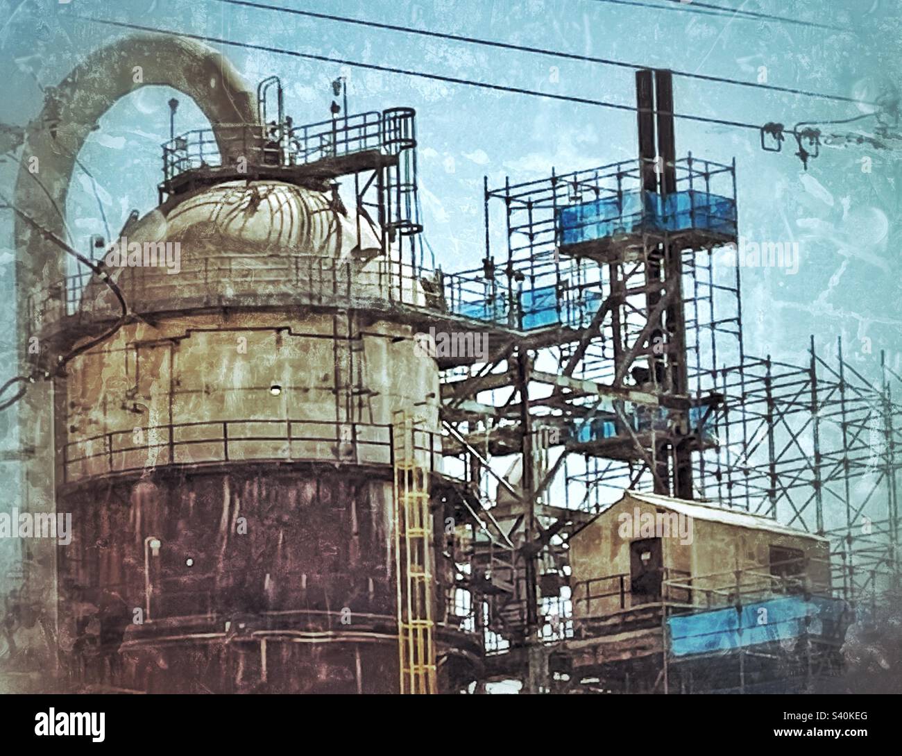 A shot of some oil refineries located along I-15 just north of Salt Lake City, Utah, USA. IOS app Snapseed was used to add additional grunge to an already grungy subject. Stock Photo