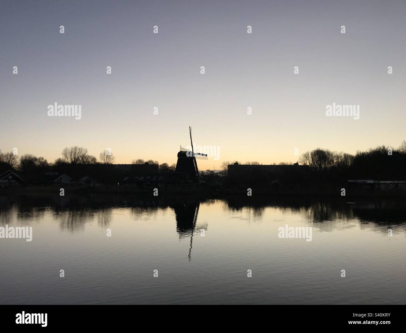 Dutch Windmill reflection in the lake- landscape Stock Photo