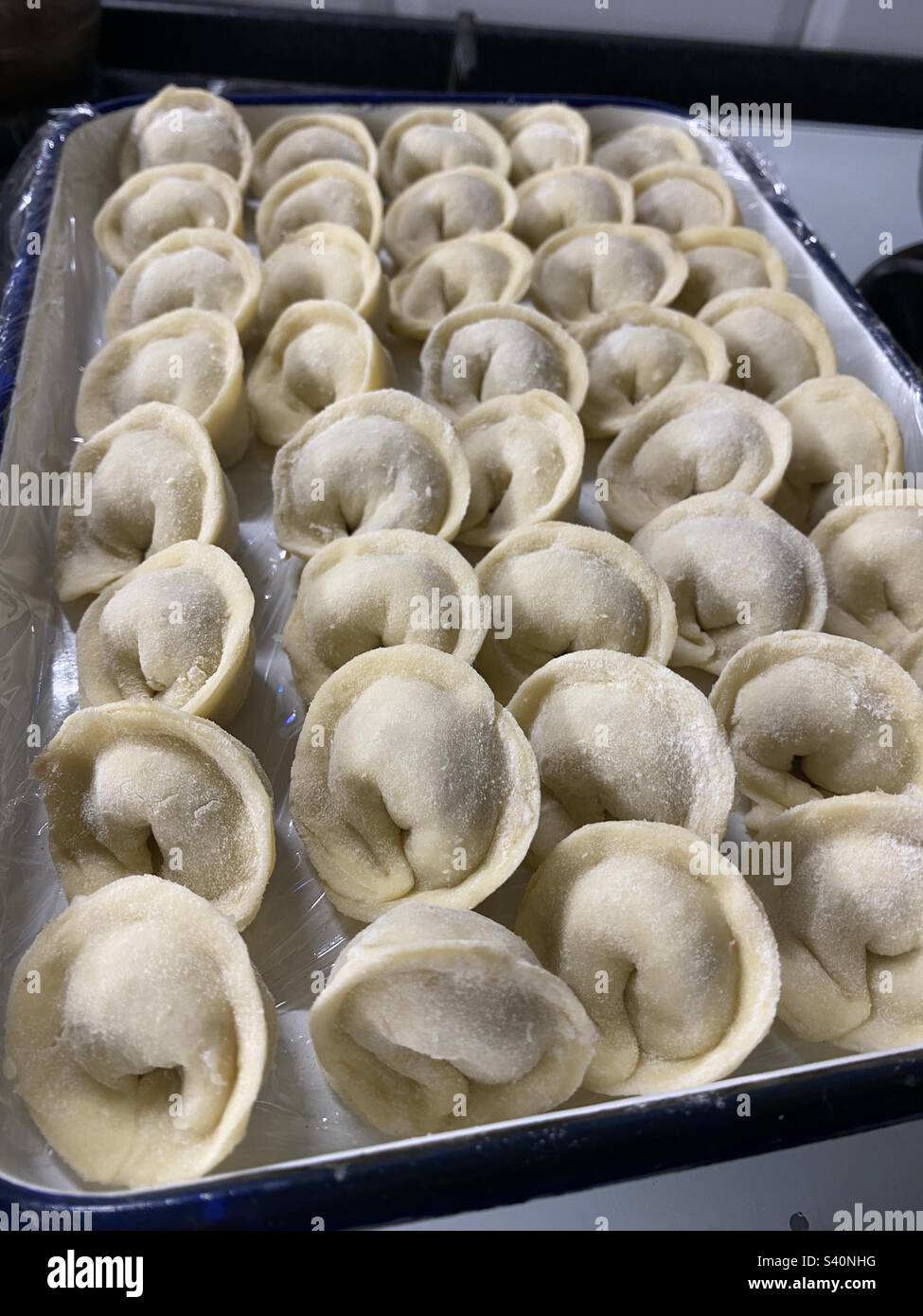 Freshly made Russian dumplings on a tray - Smartphone Captured Stock Image
