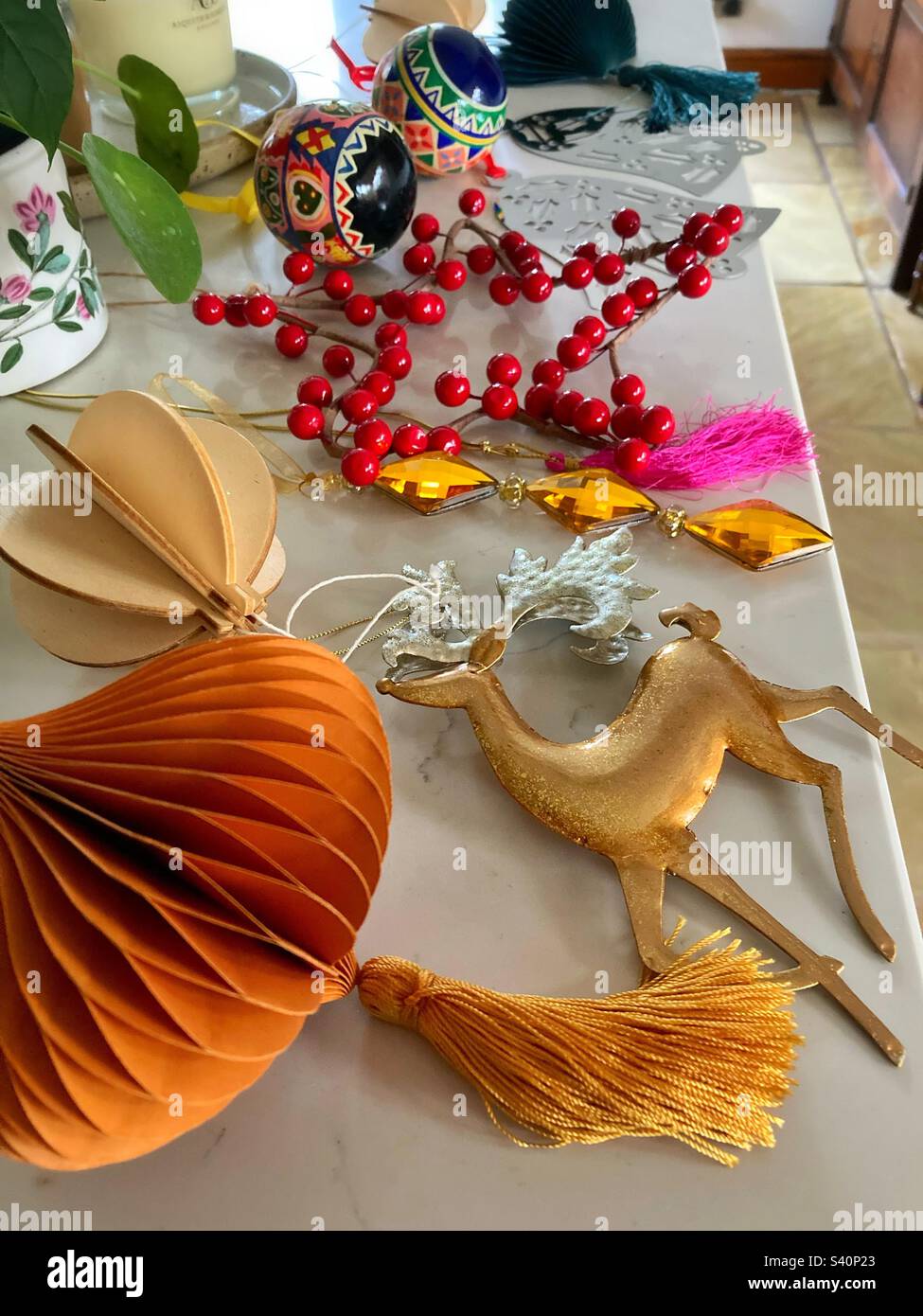 Christmas decorations laid out on a kitchen worktop ready to be put away or hung up Stock Photo
