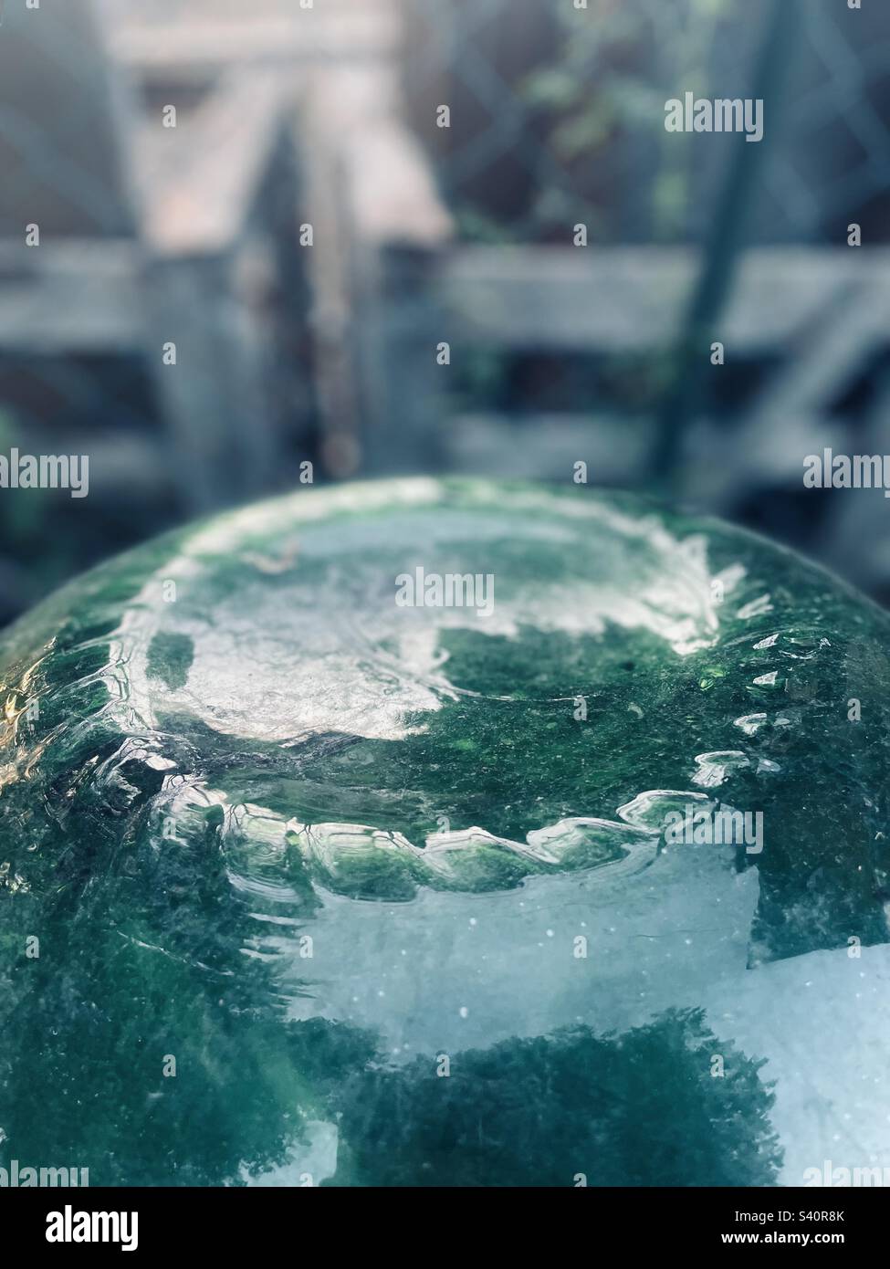 Photo of the bottom part of an upside down Vintage Large Green Carboy