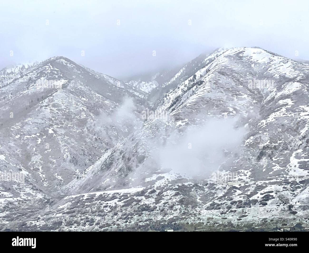 Clouds are lowering over the Wasatch Mountains just east of the Salt Lake valley in Utah, USA. - Smartphone Captured Stock Image