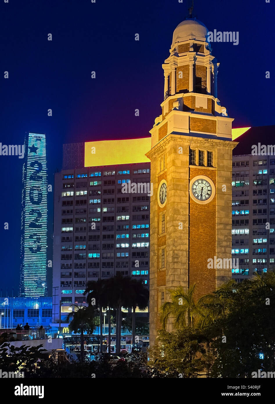 Ringing in the New Years (2023) in Hong Kong with the historic clock tower in Tsim Tsa Tsui and the iconic ICC tower in the background - Smartphone Captured Stock Image