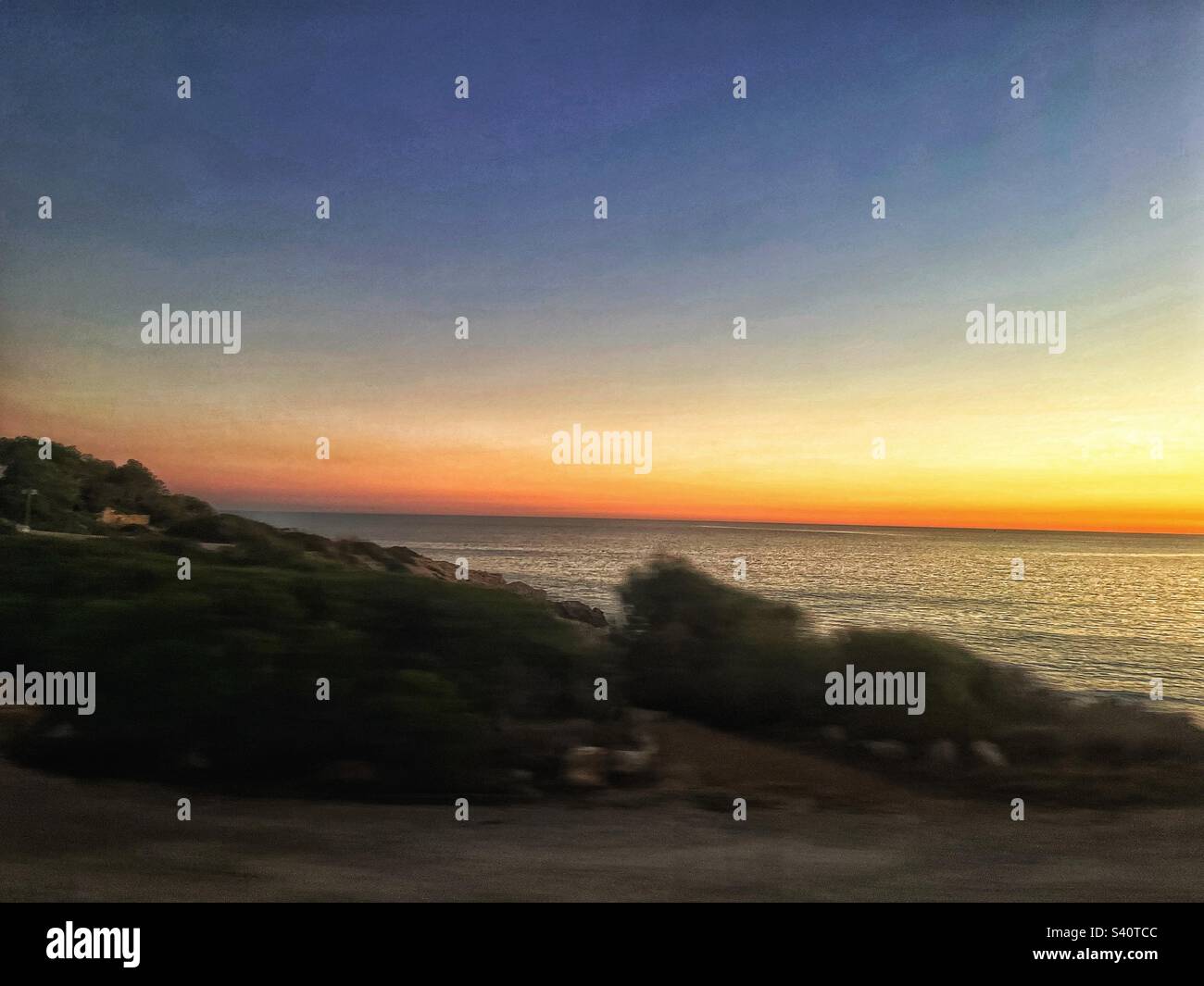 Sunset on the coastline in Spain - Mediterranean golden sunshine - Smartphone Captured Stock Image
