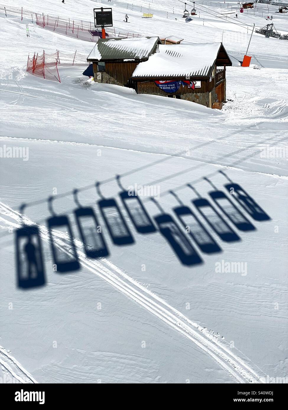 Shadow of bucket lifts in Alpe d’Huez, France, after fresh snowfall, January 2023. Stock Photo