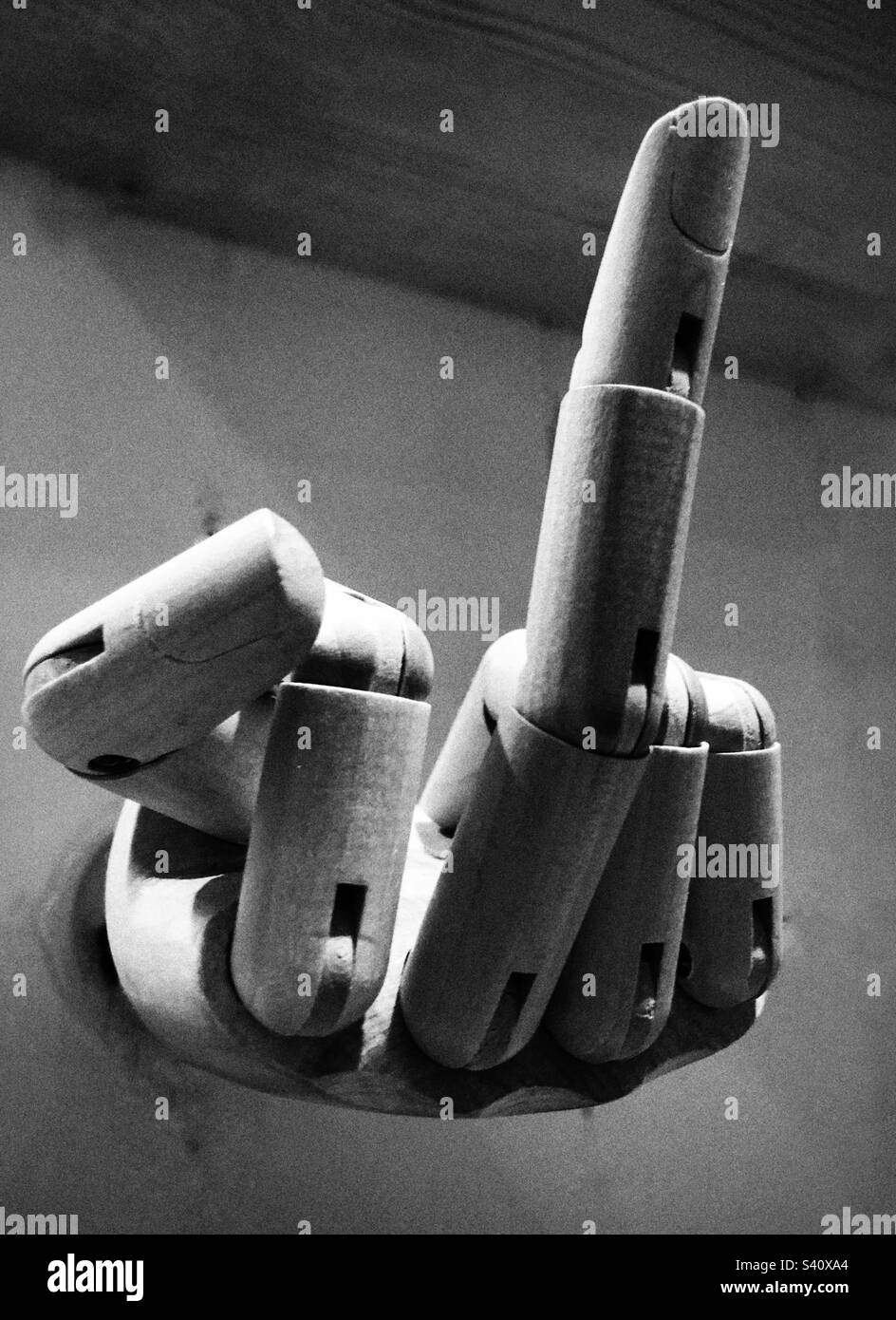 Wooden modelling hand makes a rude hand gesture - Smartphone Captured Stock Image
