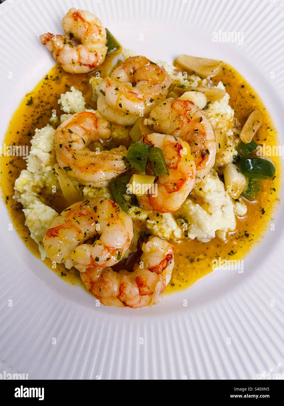 Flat lay of the traditional low country southern meal of shrimp and grits on a white plate, 2023, USA - Smartphone Captured Stock Image