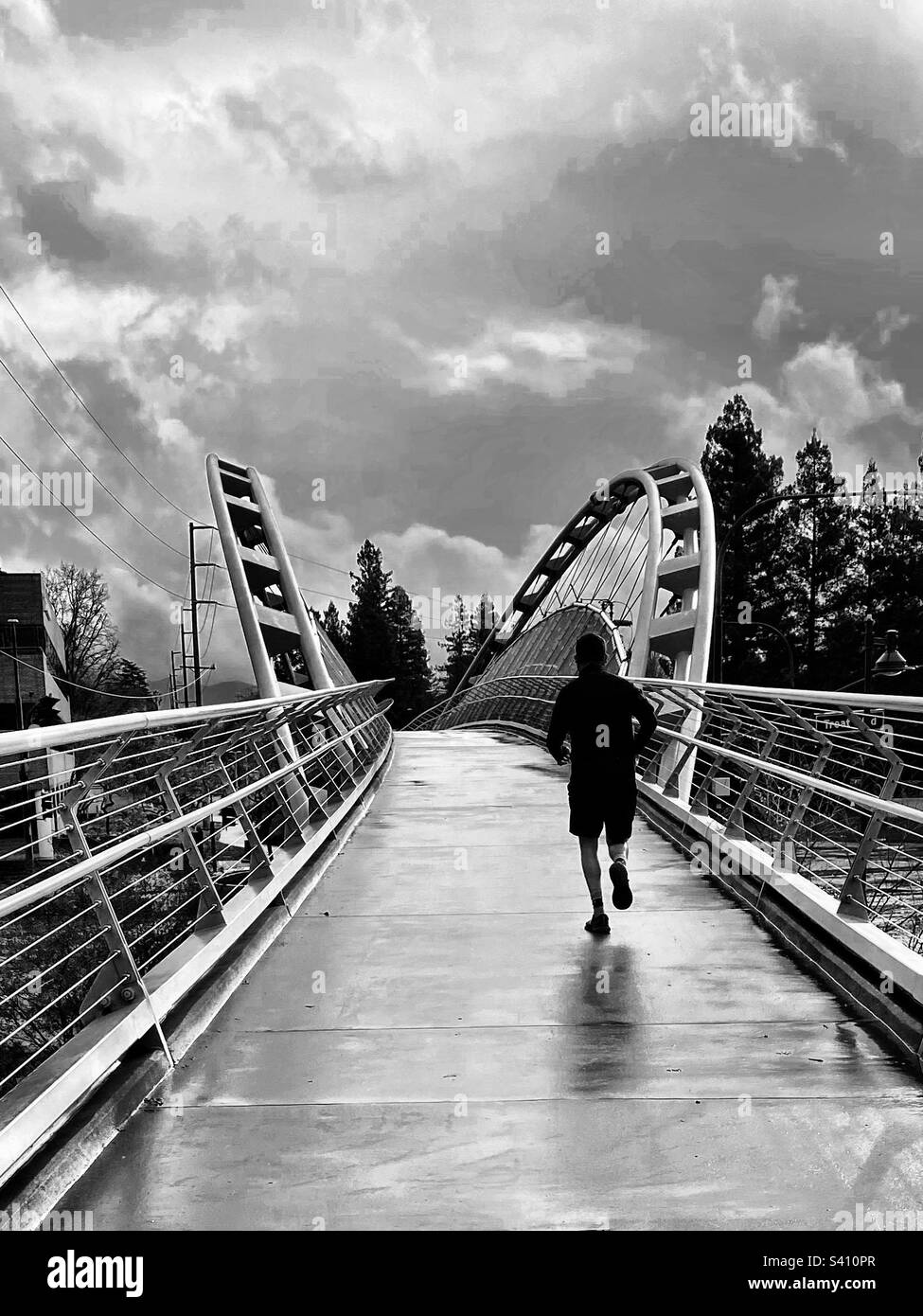 Rainy day run across a pedestrian bridge - Smartphone Captured Stock Image