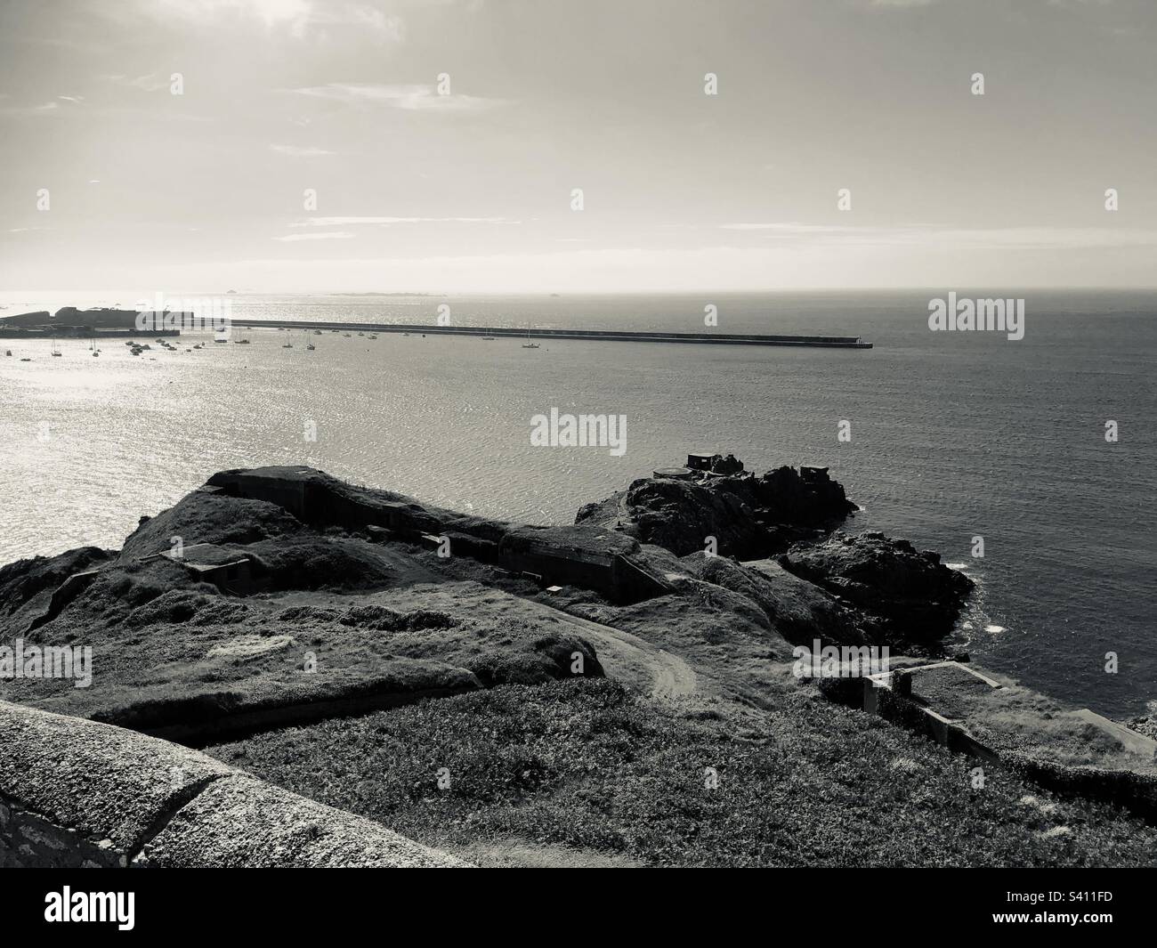 Looking from Fort Albert, Alderney, towards German fortifications at Roselle Point and the breakwater at St Anne’s Harbour. Stock Photo