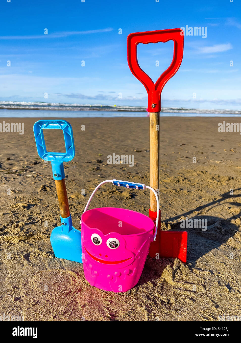 Colourful bucket and spades on a beach at Perranporth, Cornwall, UK
