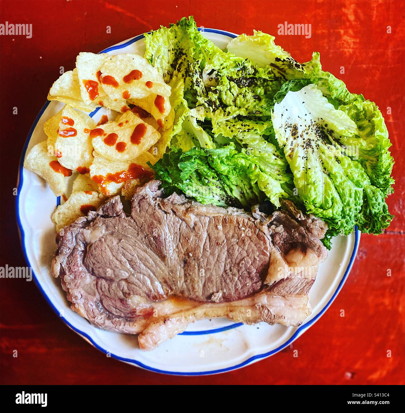 Potato chips, lettuce salad and beef meat in Queretaro, Mexico Stock