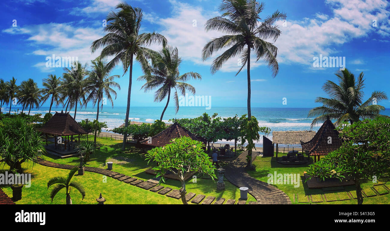 Beach side Warung in west Bali with palm trees and manicured grass Stock Photo