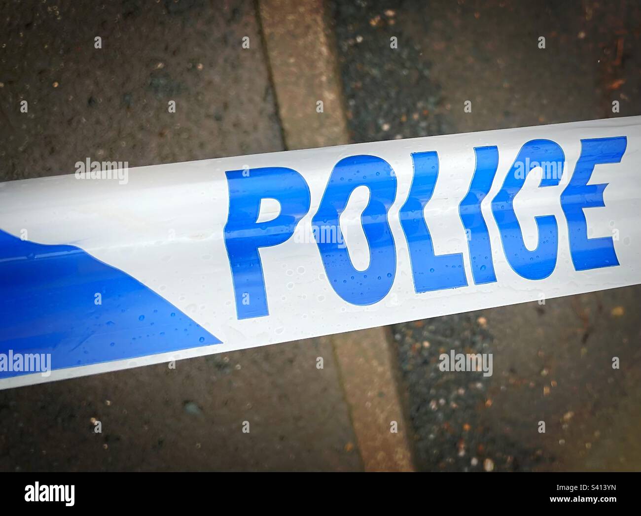 ‘POLICE’ Police ‘do not cross’ tape close up. Stock Photo
