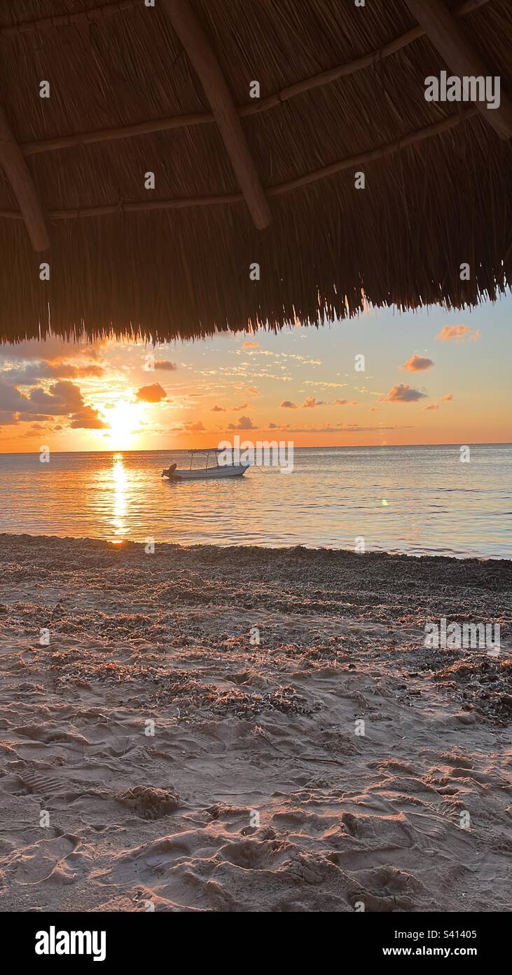 Beach, Cozumel, Mexico, Sunset, Sundown, Dusk, Twilight, Sea, Clouds, Boat, Palapa, Sand, Horizon, Romantic evening, Sun, Orange and blue sky Stock Photo