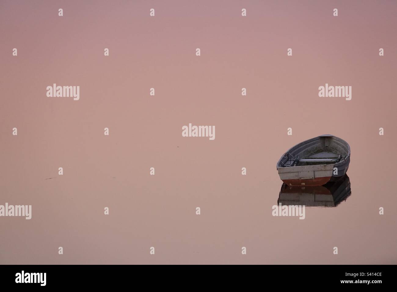 Sunrise with boat on calm water hi-res stock photography and images - Alamy