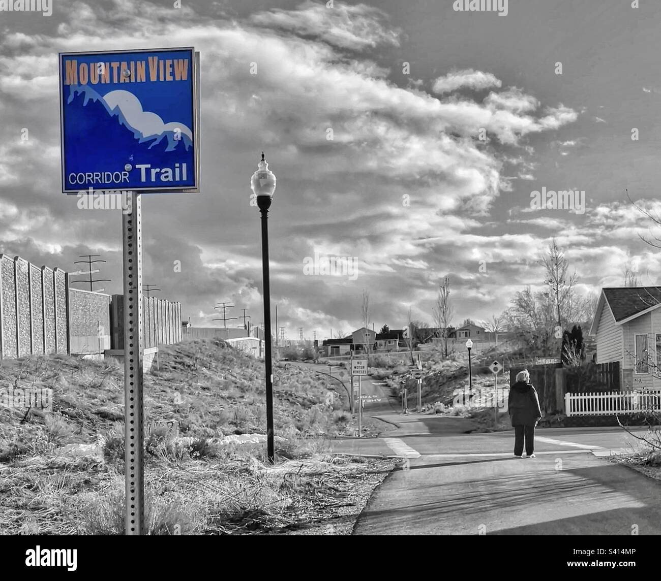 A walker along the Mountain View Corridor trail in West Valley City, Utah, USA. - Smartphone Captured Stock Image