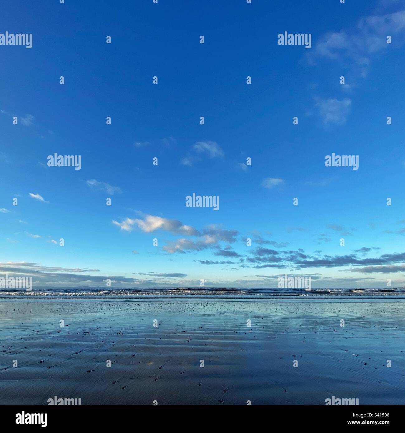 A beautiful beach view with vibrant blue sky on a cold winter day - Smartphone Captured Stock Image