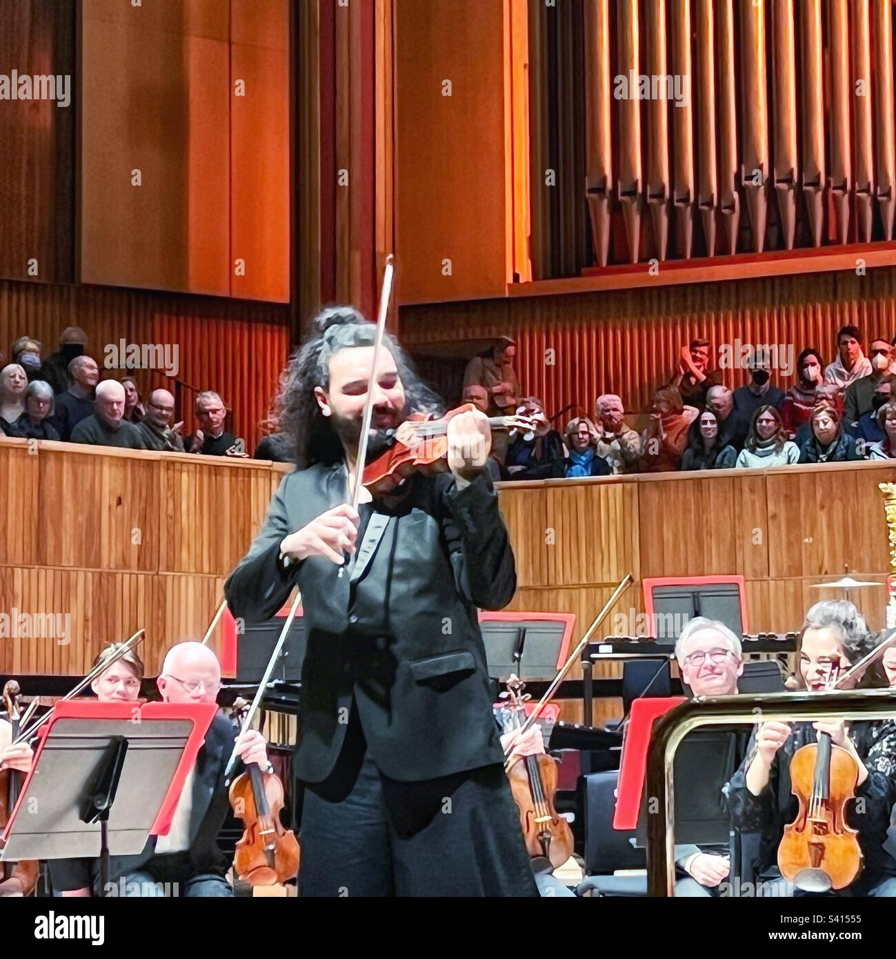 Nemanja Radulović – violinist on the stage at the Royal Festival Hall in London. He was accompanied by the Philharmonia Orchestra - Smartphone Captured Stock Image