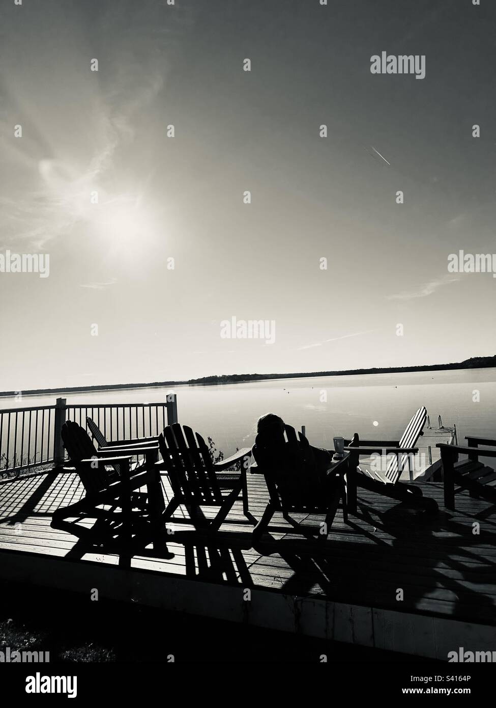 Chairs on dock at lake Stock Photo Alamy