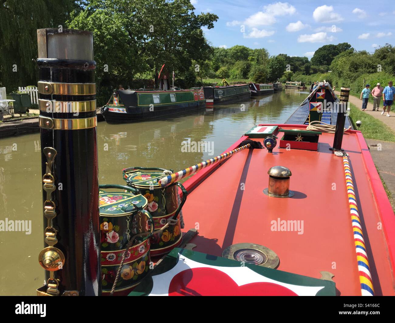 Narrow Boats on the canal, Stoke Bruerne, Towcester, chimney and painted buckets in the foreground, June 2017, Pic 39. Stock Photo