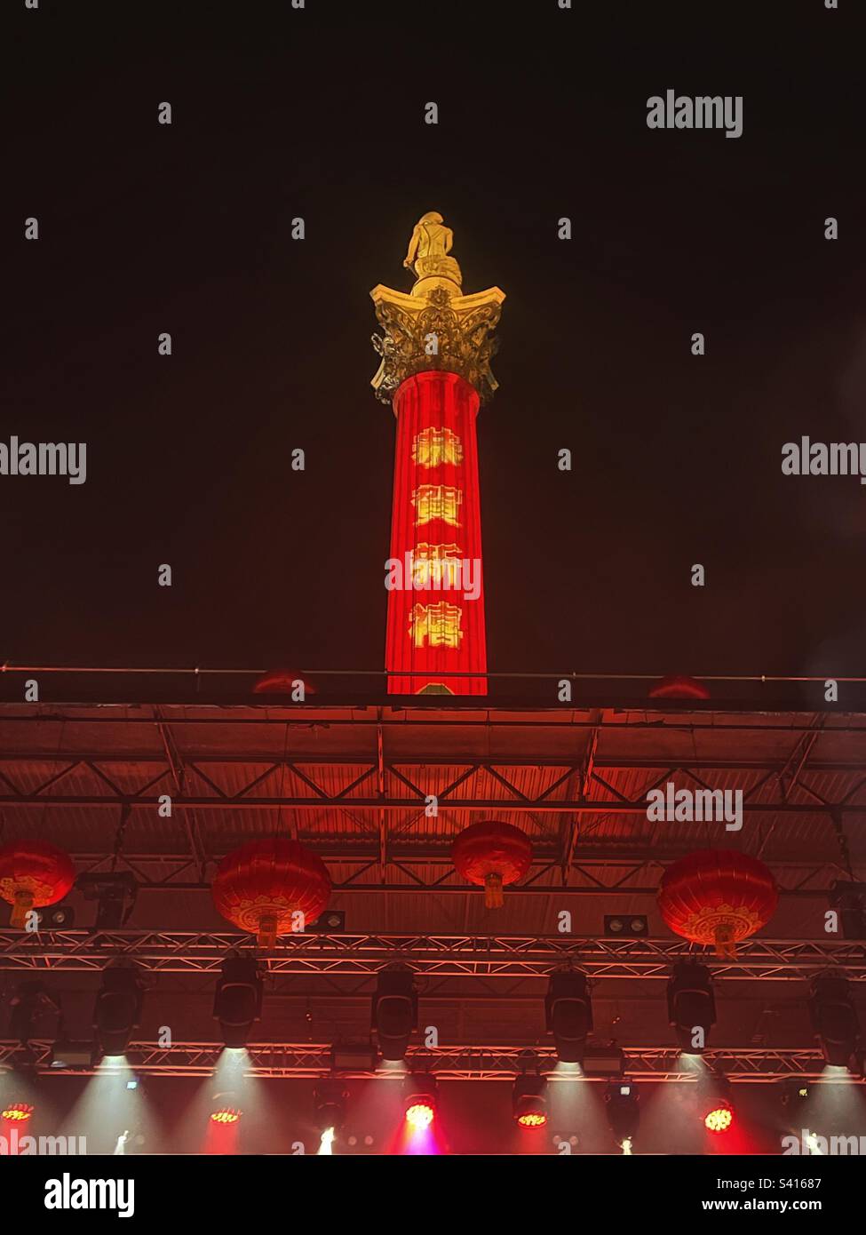 Stage lights for the Lunar New Year, Chinese New Year of the Rabbit in London’s Trafalgar Square with message on Nelson’s Column - London Chinatown Chinese Association event. Closing ceremony. - Smartphone Captured Stock Image