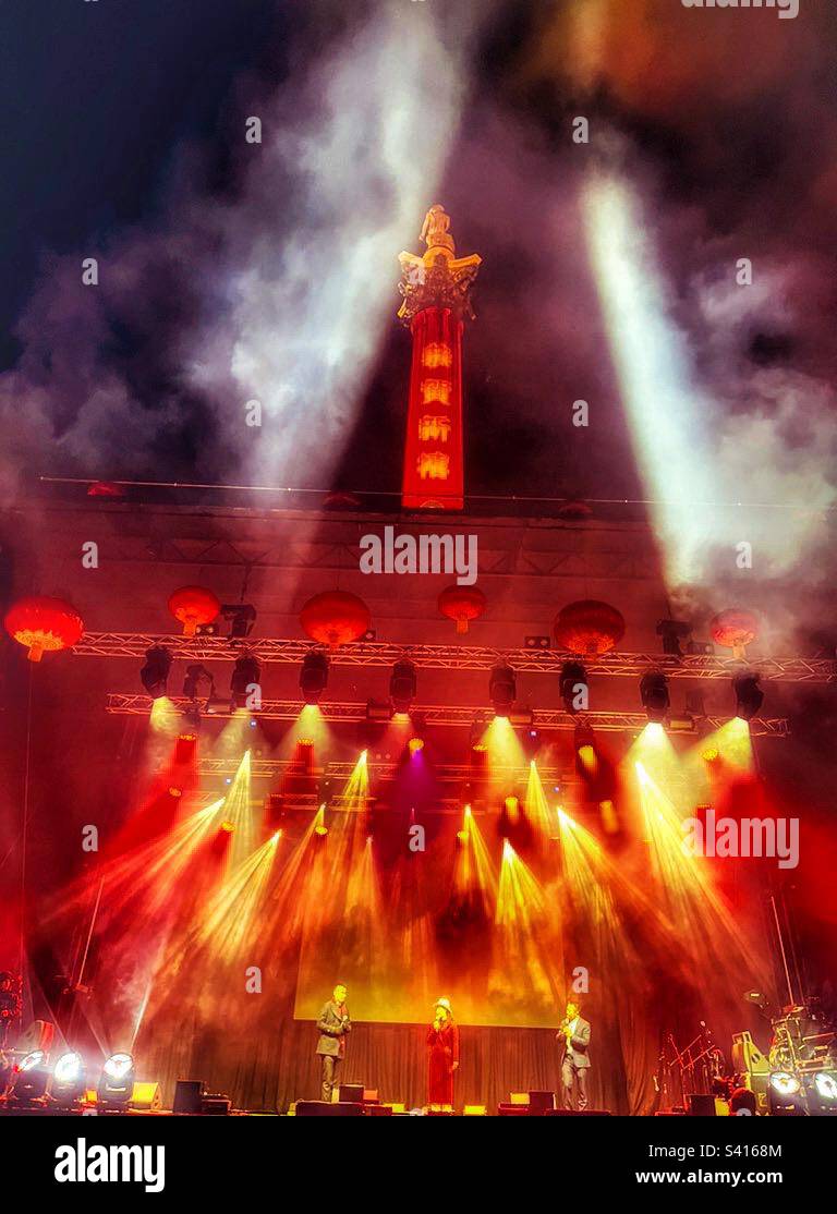 Dramatic lighting at the closing ceremony of the Chinese New Year celebrations in London. Trafalgar Square with Nelson’s Column illuminated in red and gold. Lunar New Year 2023. - Smartphone Captured Stock Image