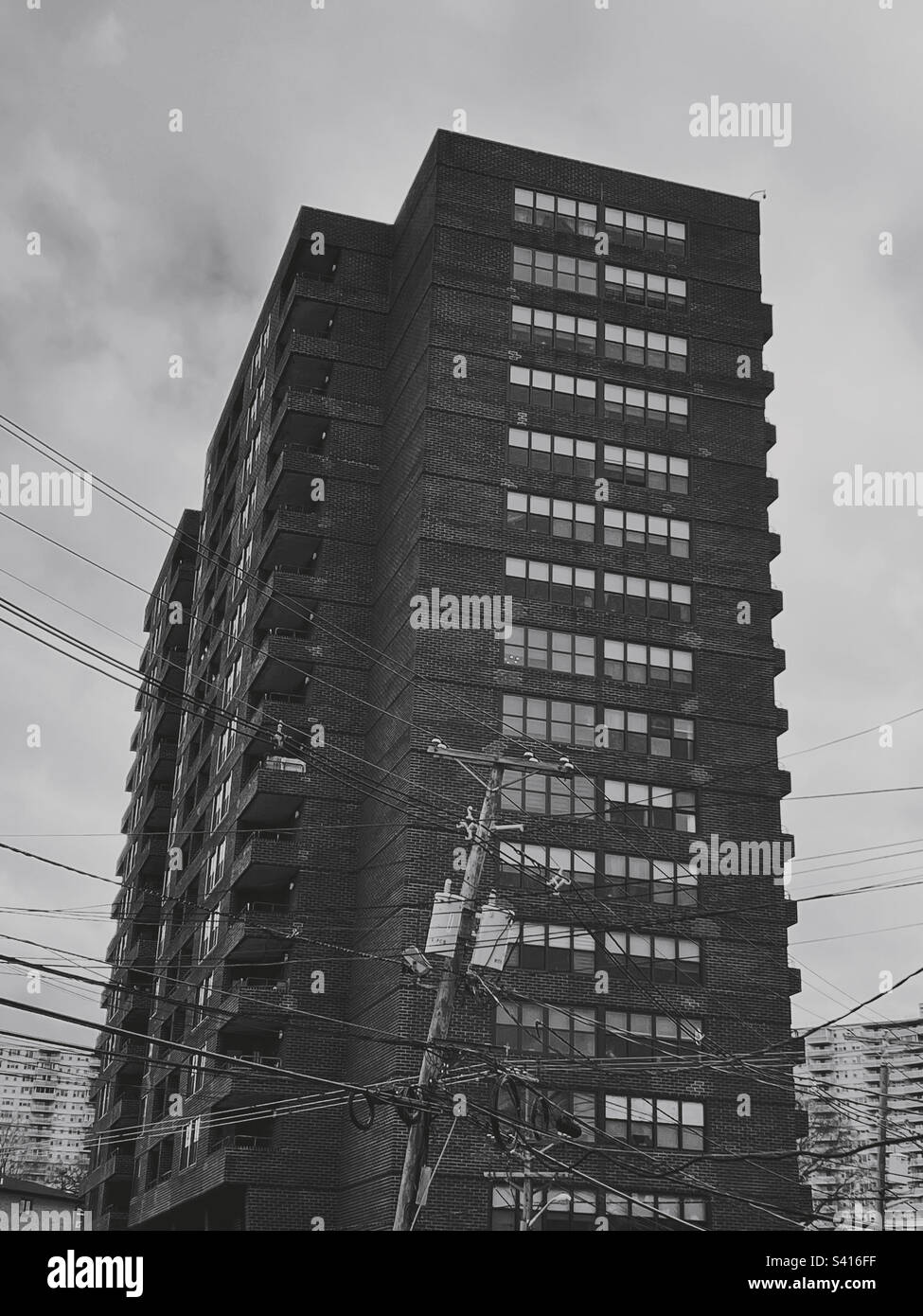 An apartment building in Fort Lee, New Jersey, with a mess of utility lines in the foreground. - Smartphone Captured Stock Image
