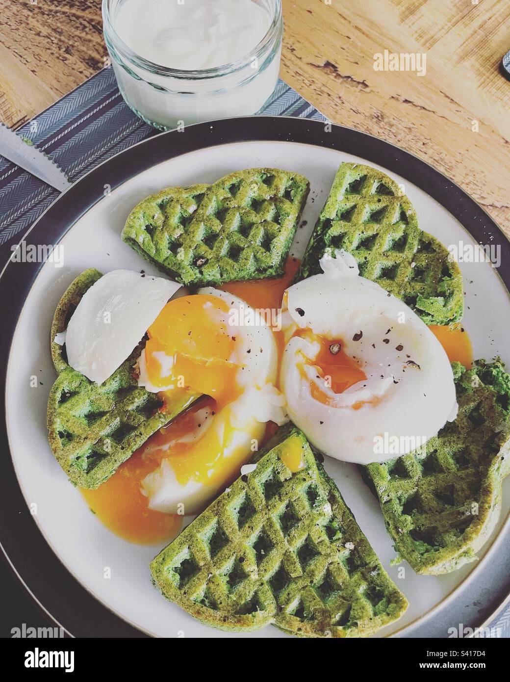Spinach Waffles and poached eggs Stock Photo Alamy