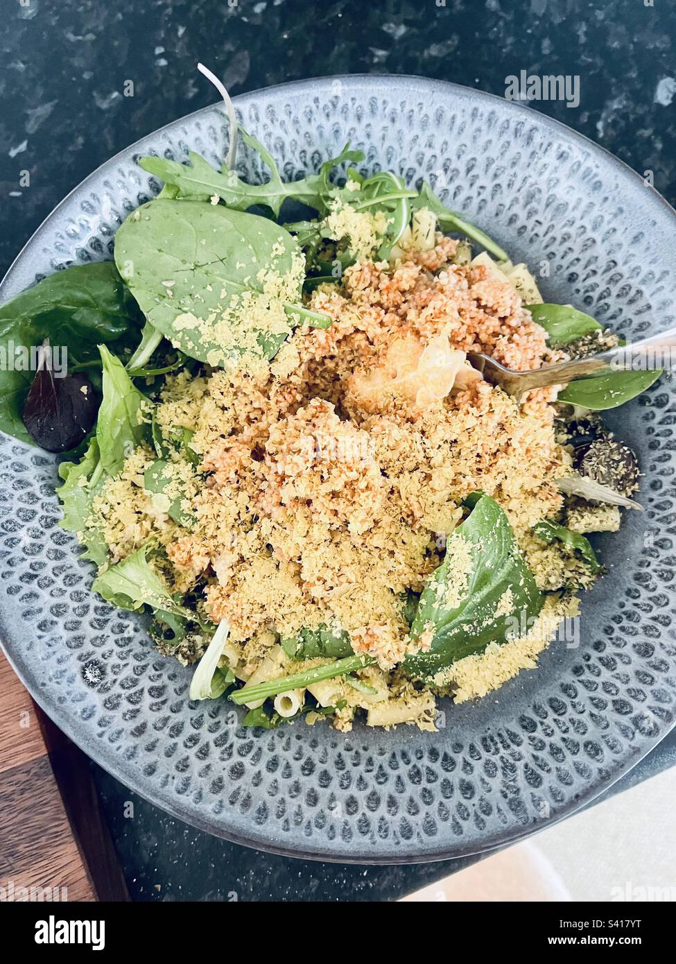 Bowl of Goodness vegan macaroni cheese, couscous, salad leaves and