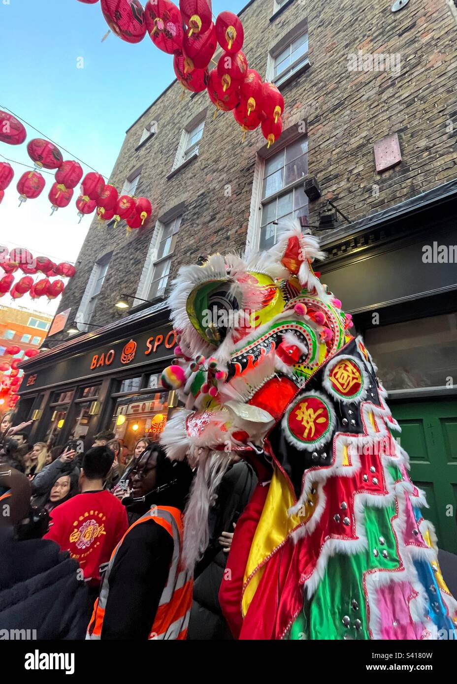 Crowd with the dragon in the streets of Chinatown Soho London for the Luna New Year - Smartphone Captured Stock Image