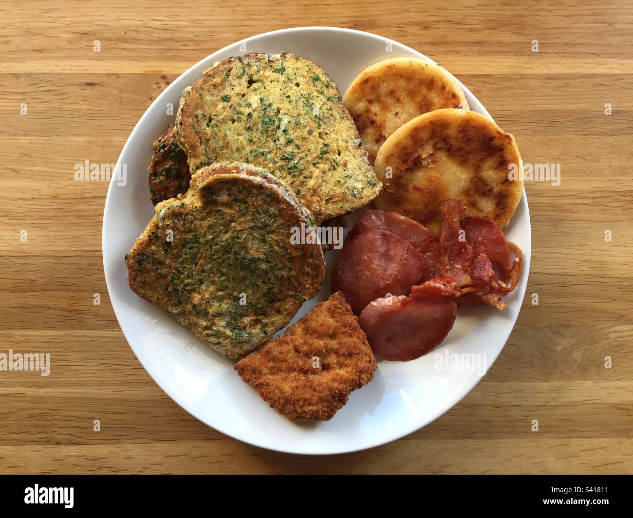 Lunch fry up with eggy bread, crispy bacon, chicken in breadcrumbs and
