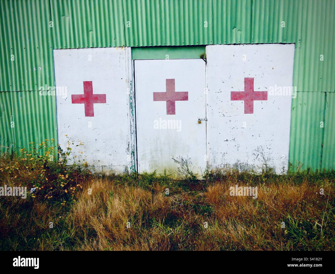 Red crosses on doorways from an unused bullring in Costa Rica - Smartphone Captured Stock Image