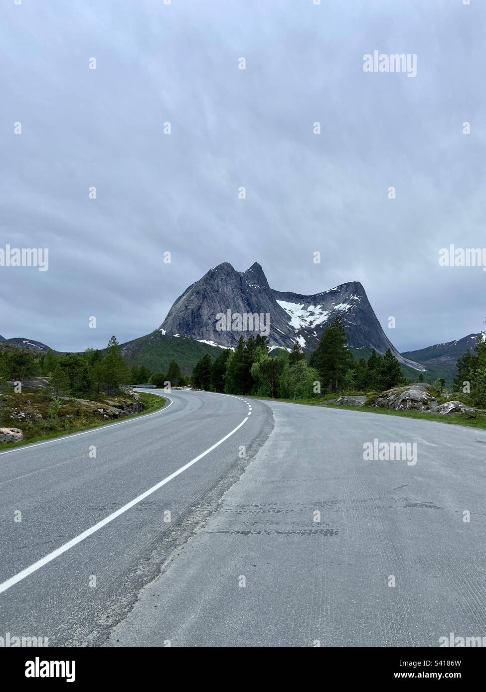 Mountain Stortinden in Nordland, Norway on a cloudy June day. Shot from the roadside, there is also a road in the photo. - Smartphone Captured Stock Image