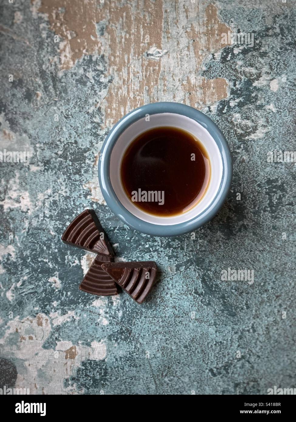 Cup of black coffee and triangles of chocolate - Smartphone Captured Stock Image