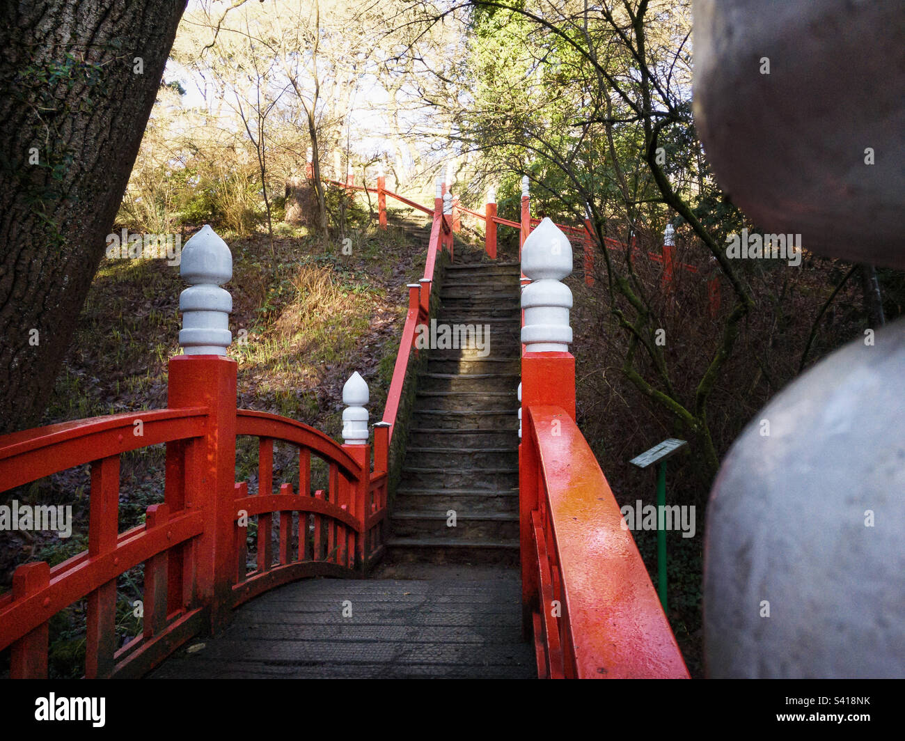 Red and white bridge and banister on Japanese bridge in Clyne gardens Swansea. - Smartphone Captured Stock Image