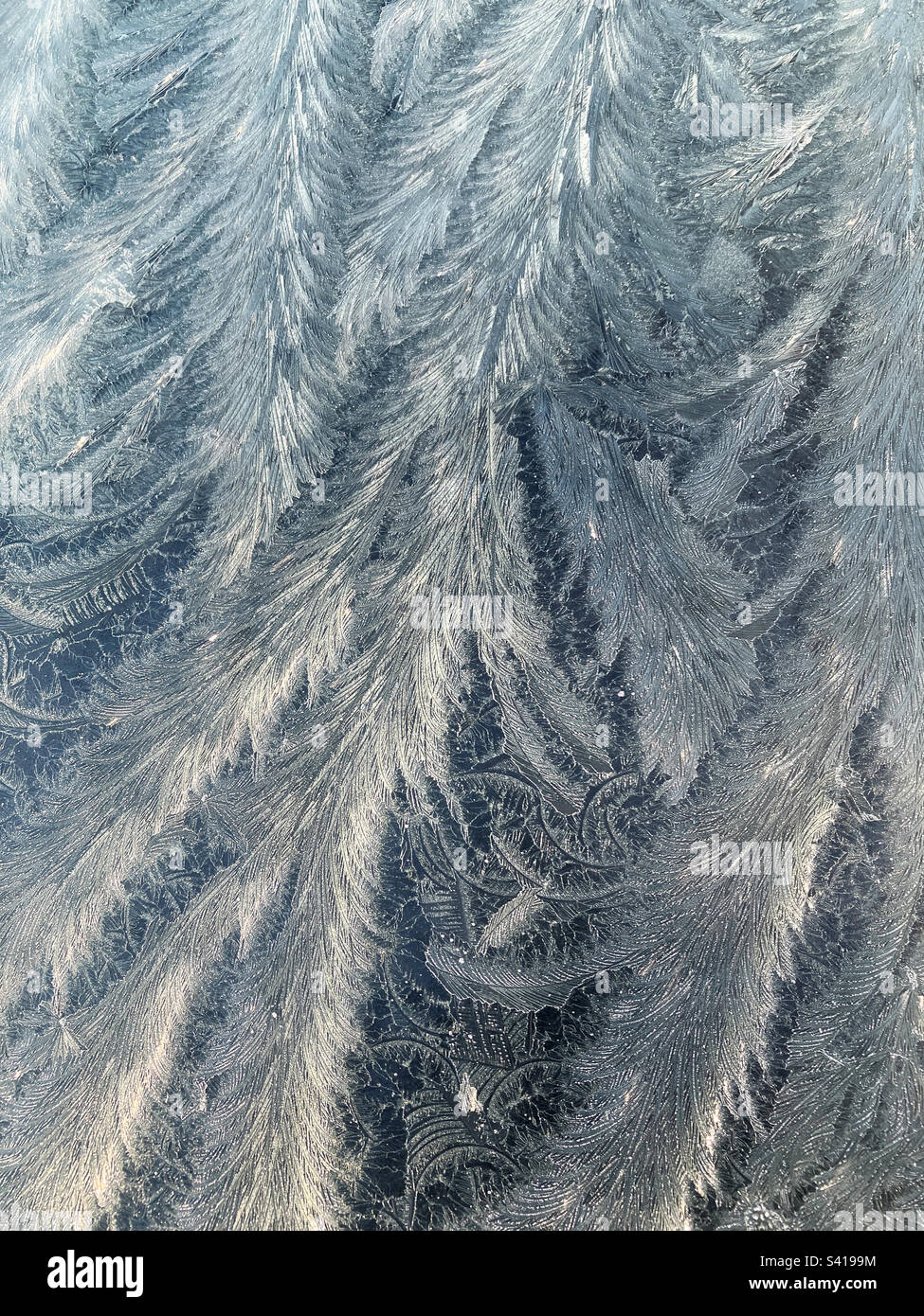 Abstract background, natural texture pattern of ice and frost on windscreen glass Stock Photo