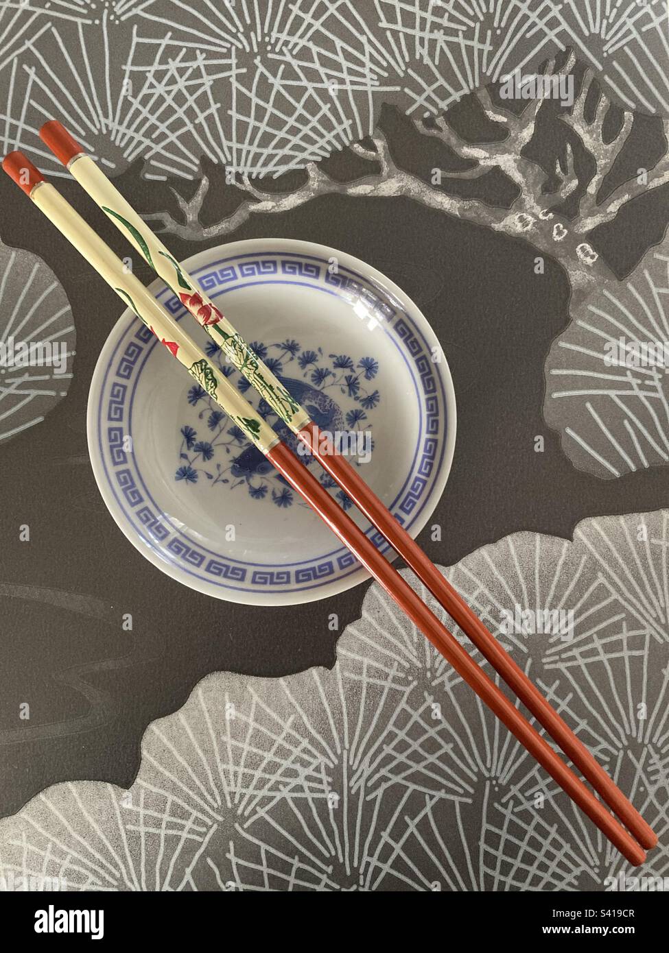 A pair of chopsticks on a Chinese dish Stock Photo