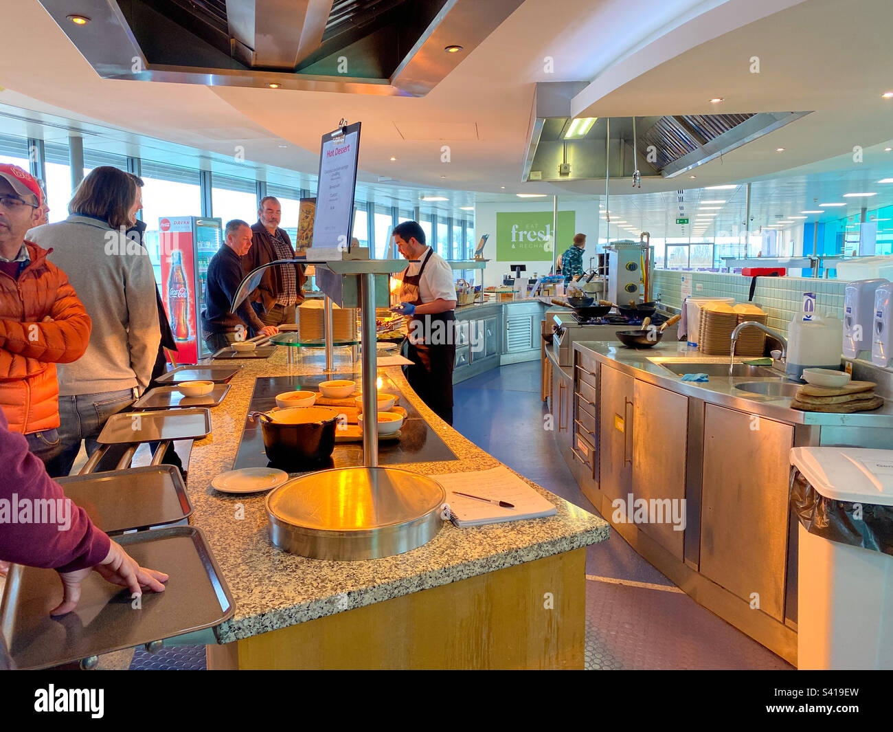People queuing in the office canteen. - Smartphone Captured Stock Image