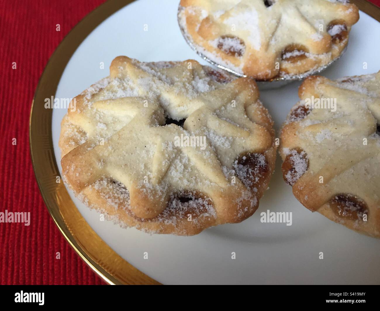 Mince pies on a white plate with a gold rim, traditional Christmas treats, pic 4. - Smartphone Captured Stock Image