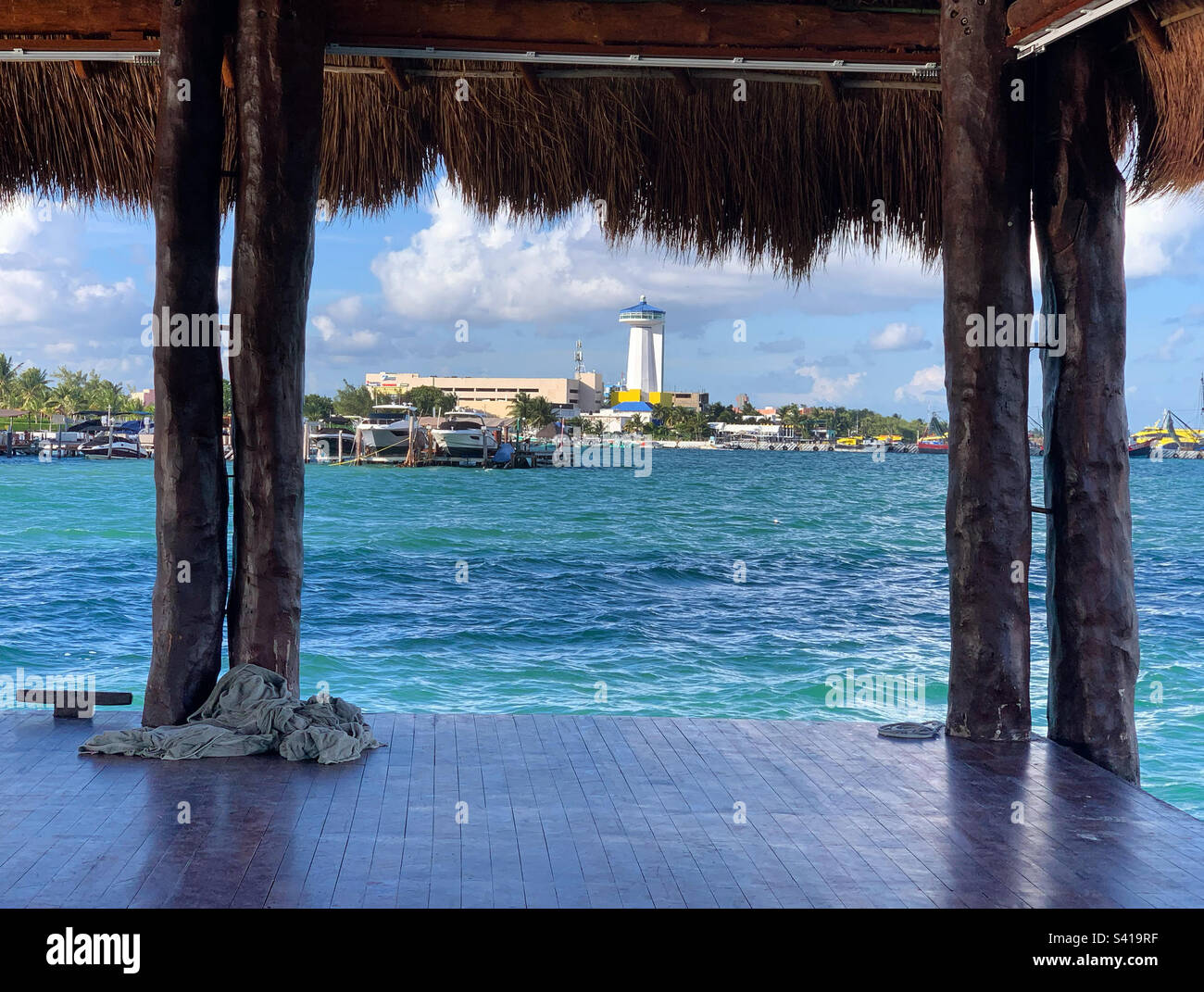 Under a palapa roof on the water at the Dreams Vista Cancun Golf and Spa Resort, Cancun, Quintana Roo, Mexico - Smartphone Captured Stock Image