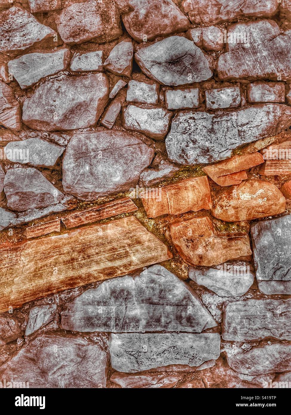 A rough hewn wall of stone, with a grunge and HDR effect. - Smartphone Captured Stock Image