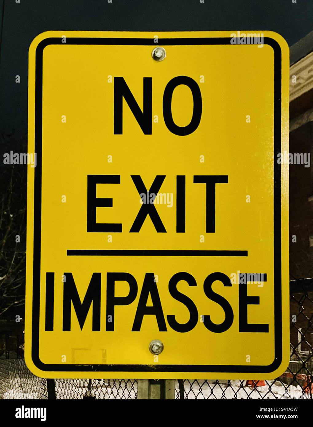 Bright yellow bilingual no exit sign Stock Photo - Alamy